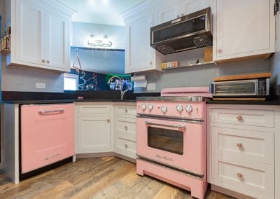 retro kitchen white shaker cabinets pink stove retro 1950
