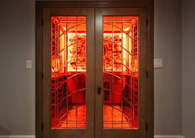 Home Wine Cellar in Naperville, Illinois glass doors inset cabinetry brown stain wine storage